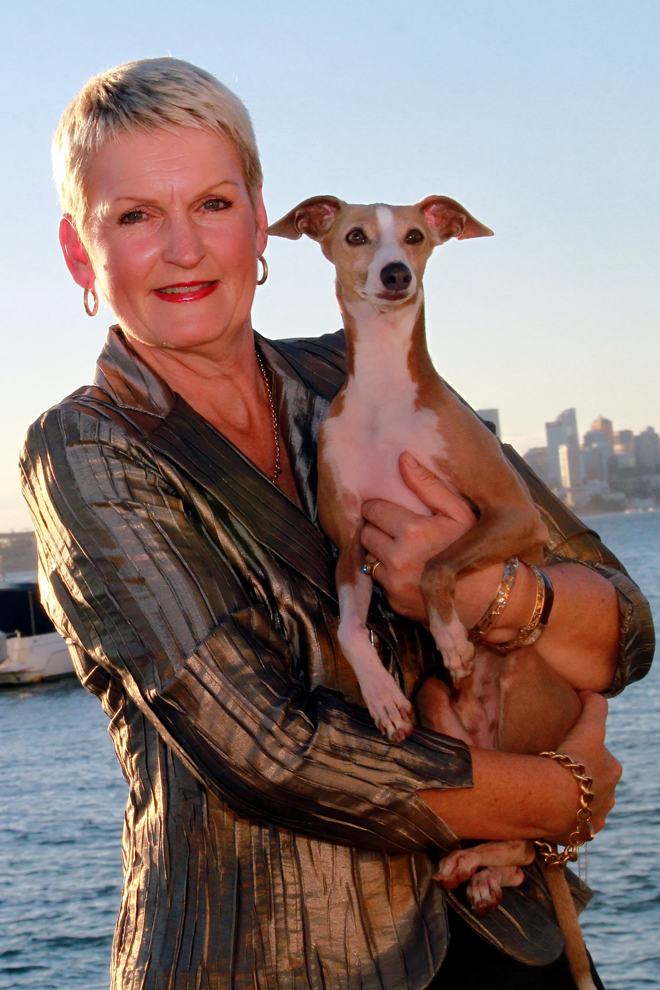 Sandy Reeve holding Nova, photographed on Sydney Harbour